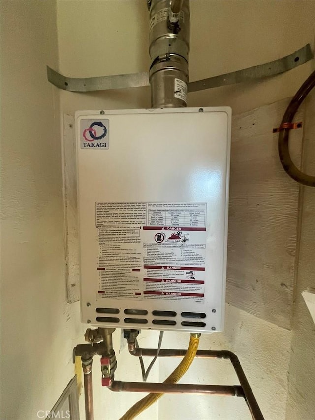 utility room featuring water heater