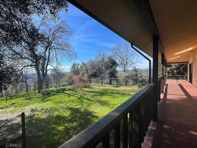 view of yard featuring a fenced backyard and a balcony