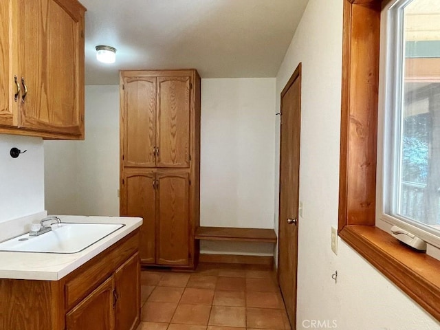 washroom featuring a sink and light tile patterned floors