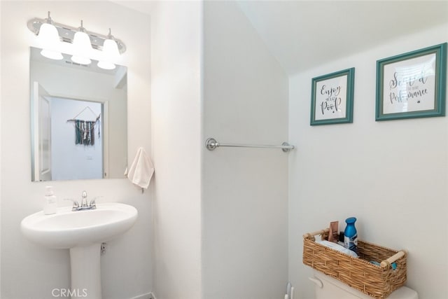 half bathroom featuring toilet