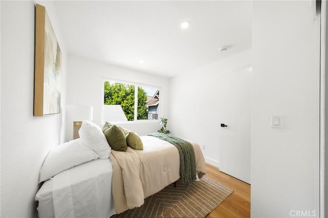 bedroom featuring light wood-type flooring and recessed lighting