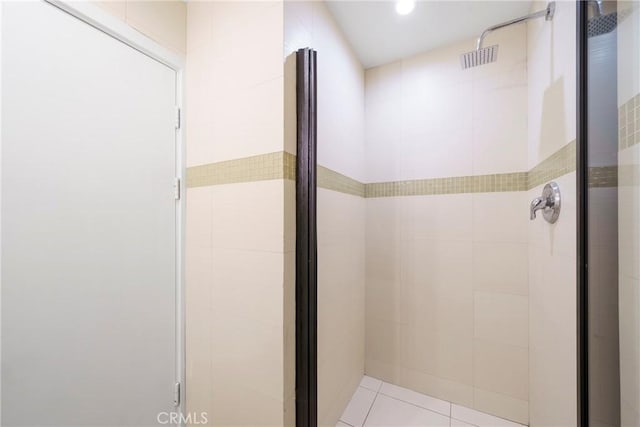 bathroom with tile patterned flooring and a stall shower