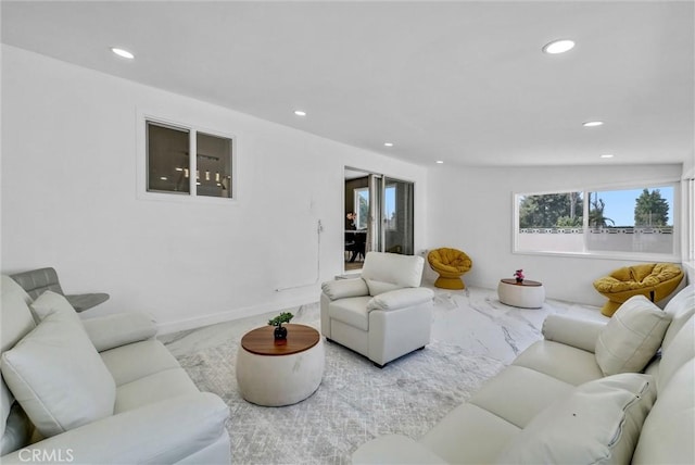 living area with marble finish floor, baseboards, and recessed lighting