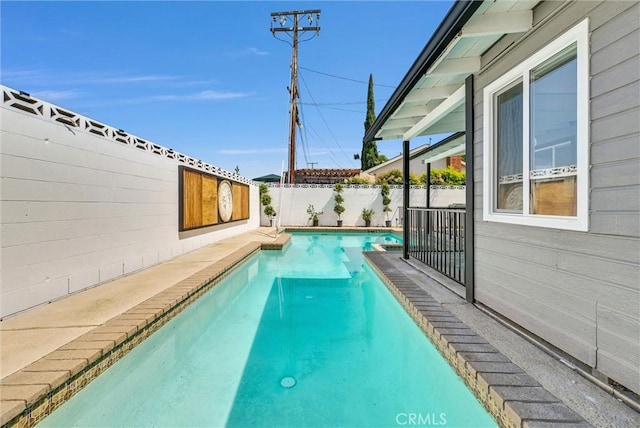 view of swimming pool with a fenced backyard and a fenced in pool