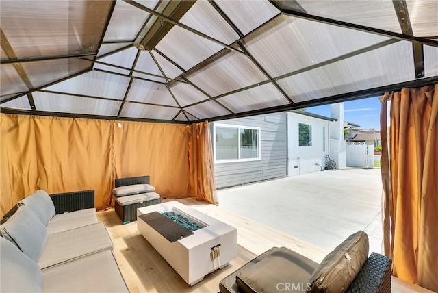 view of patio featuring an outdoor living space with a fire pit and a gazebo
