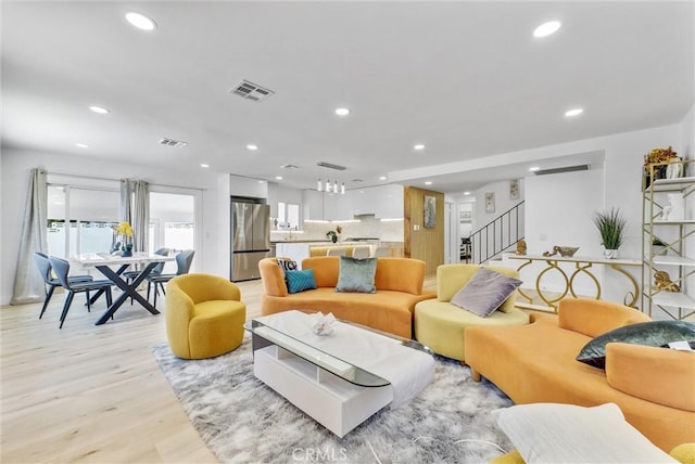 living room featuring recessed lighting, stairs, and visible vents