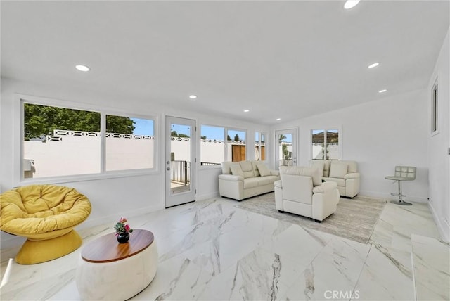 living room featuring baseboards, recessed lighting, and marble finish floor