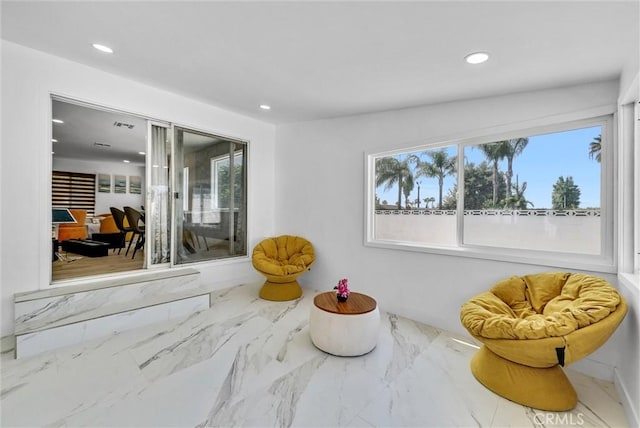 interior space featuring recessed lighting and marble finish floor