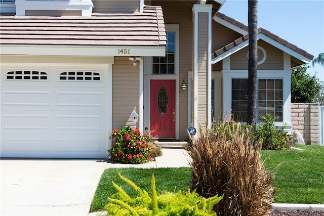entrance to property featuring concrete driveway