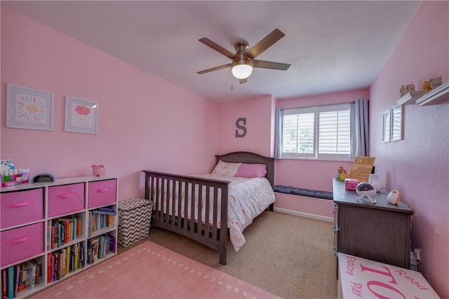 carpeted bedroom with baseboards and a ceiling fan