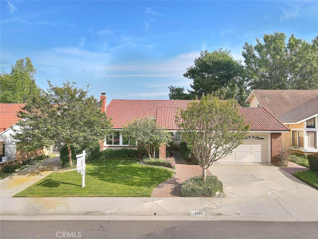 3480 Falcon Ridge Rd, Diamond Bar, CA 91765 - view of front facade featuring a tiled roof, a front lawn, an attached garage, a chimney, and concrete driveway