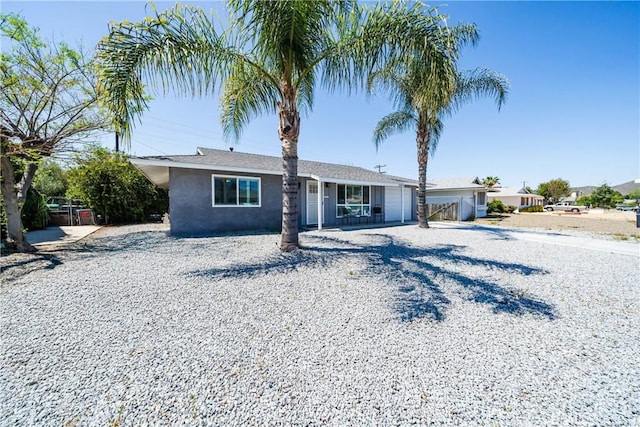 29251 Pebble Beach Dr, Menifee, CA 92586 - view of front of home with fence, driveway, and stucco siding