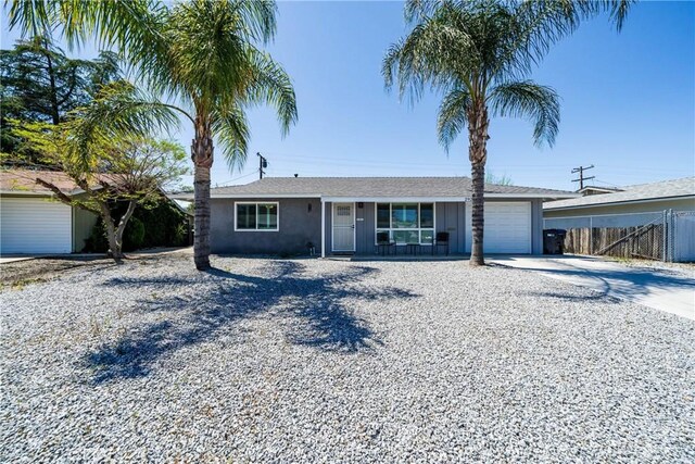 29251 Pebble Beach Dr, Menifee, CA 92586 - ranch-style home with a garage, stucco siding, fence, and concrete driveway