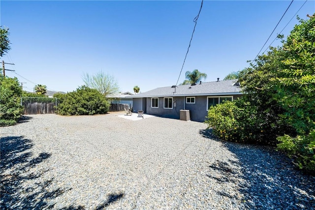 29251 Pebble Beach Dr, Menifee, CA 92586 - rear view of house featuring fence, a patio area, and stucco siding