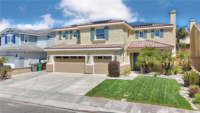 mediterranean / spanish house featuring solar panels, a tiled roof, an attached garage, concrete driveway, and stucco siding