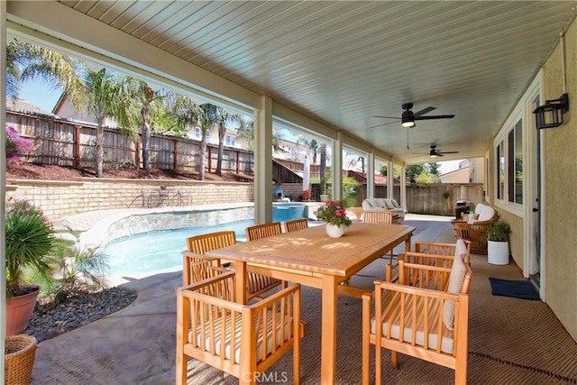 view of patio / terrace with a ceiling fan, a fenced backyard, a fenced in pool, and outdoor dining area