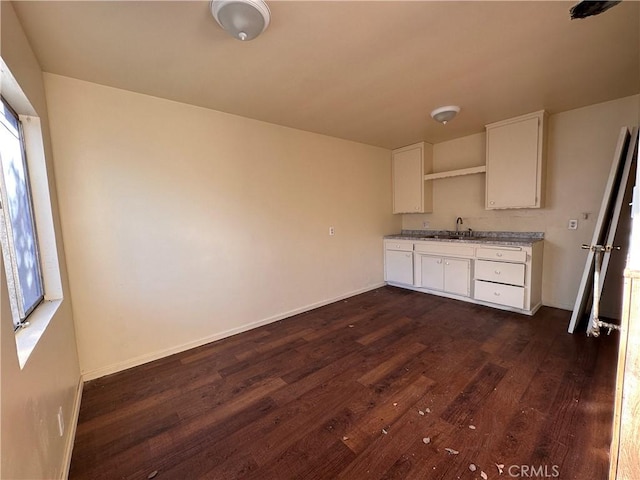 kitchen featuring white cabinets, baseboards, and dark wood-style floors