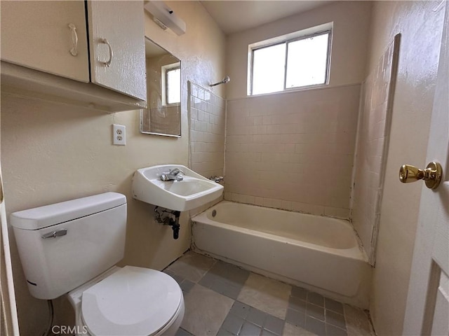 bathroom with  shower combination, a sink, and toilet