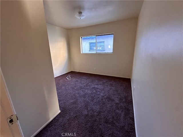 carpeted spare room with baseboards