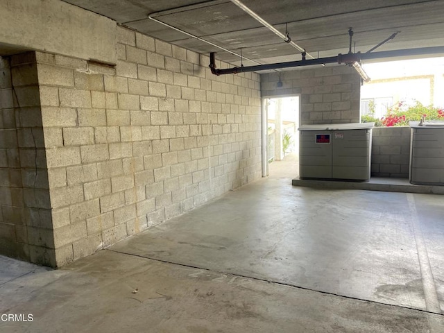 garage featuring a sink and concrete block wall