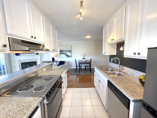 kitchen featuring under cabinet range hood, white cabinetry, a sink, and appliances with stainless steel finishes
