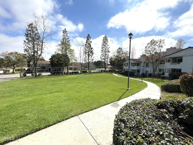 surrounding community featuring a yard and a residential view