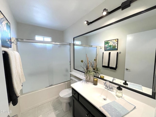 full bath featuring tile patterned floors, enclosed tub / shower combo, vanity, and toilet