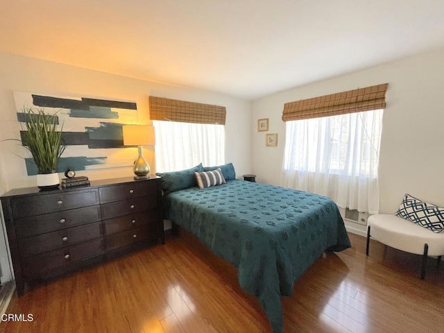 bedroom with dark wood-style flooring