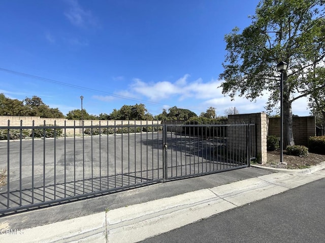 view of gate featuring fence
