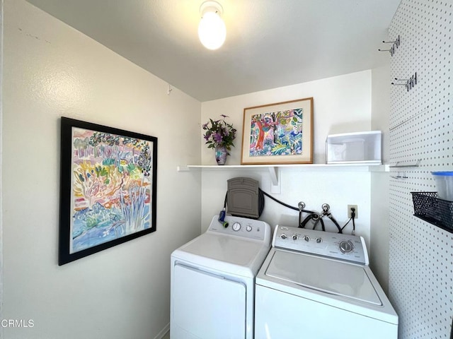 washroom with washer and clothes dryer and laundry area