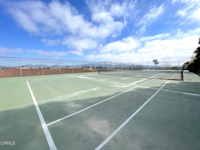 view of sport court with fence