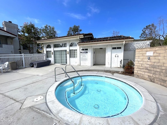 view of swimming pool with a patio area and fence
