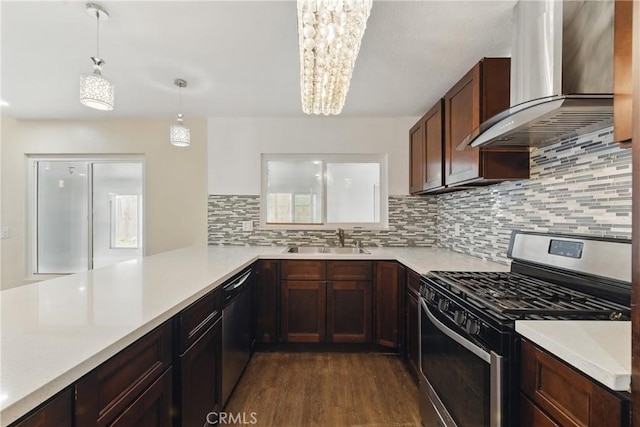 kitchen featuring wall chimney exhaust hood, stainless steel gas range, light countertops, a sink, and dishwasher