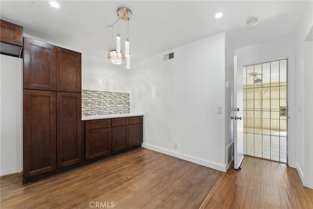interior space with visible vents, baseboards, a chandelier, recessed lighting, and wood finished floors