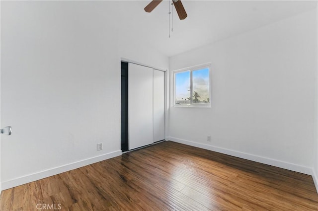 unfurnished room with baseboards, ceiling fan, and wood finished floors