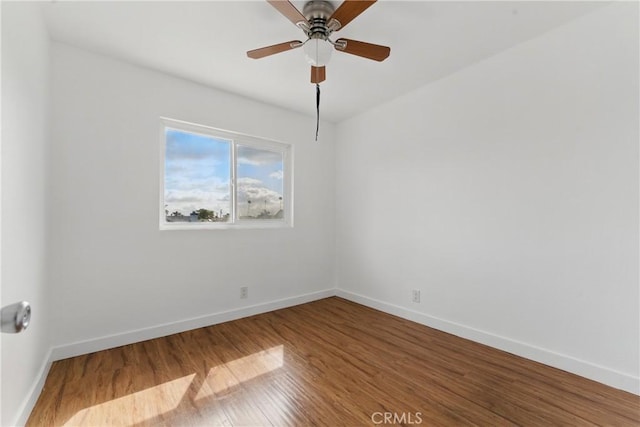 unfurnished room with baseboards, a ceiling fan, and wood finished floors