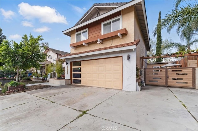 view of front of home featuring fence, a garage, stucco siding, and driveway