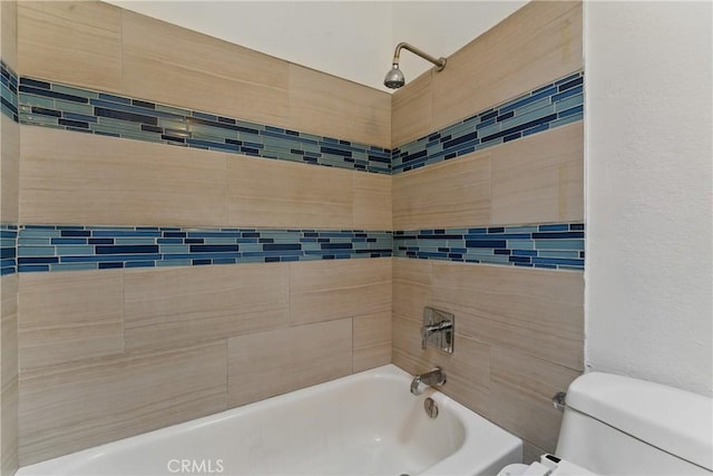 bathroom with toilet and bathing tub / shower combination
