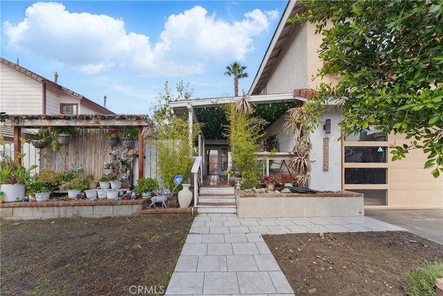 view of front of property with stucco siding and fence