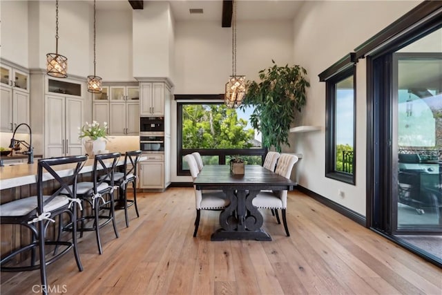 121 Avenida Pizarro, San Clemente, CA 92672 - dining room featuring a towering ceiling, light wood-style floors, beam ceiling, baseboards, and a chandelier
