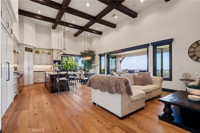 121 Avenida Pizarro, San Clemente, CA 92672 - living area featuring a towering ceiling, healthy amount of natural light, coffered ceiling, light wood-style flooring, and beam ceiling