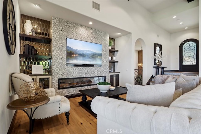 121 Avenida Pizarro, San Clemente, CA 92672 - living area featuring arched walkways, wood finished floors, recessed lighting, a fireplace, and built in features
