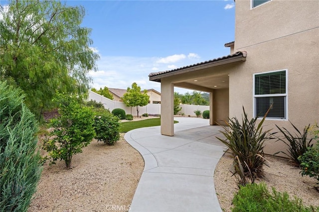 view of community with fence and a patio