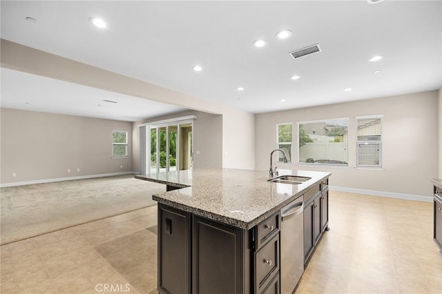 kitchen featuring a center island with sink, visible vents, a sink, and a healthy amount of sunlight