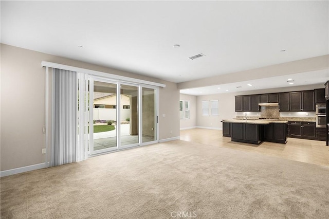 45600 Gresham, Temecula, CA 92592 - unfurnished living room with light colored carpet, baseboards, a sink, and recessed lighting