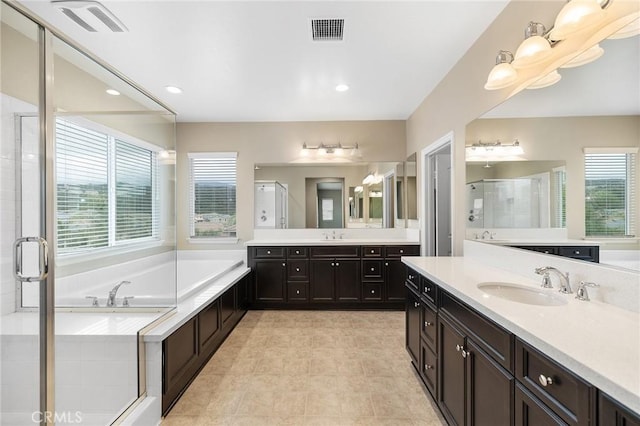 full bathroom with a garden tub, visible vents, a sink, and a stall shower