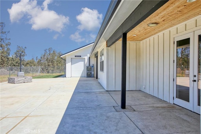 view of patio with fence and concrete driveway