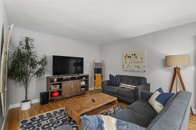 living room featuring wood finished floors and baseboards