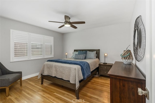 bedroom featuring light wood-type flooring, baseboards, and a ceiling fan