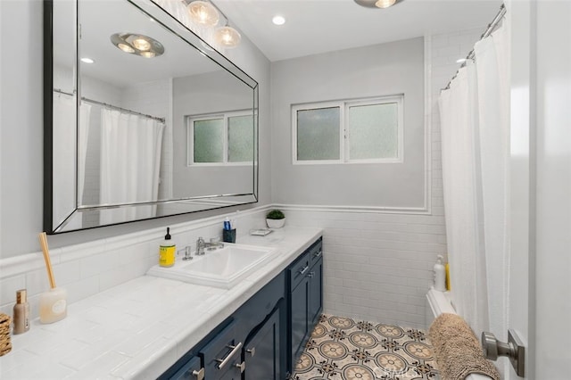 bathroom featuring vanity, tile walls, tile patterned floors, a wainscoted wall, and a shower with curtain